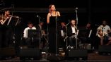 Meg Davis on stage singing a Turkish song.